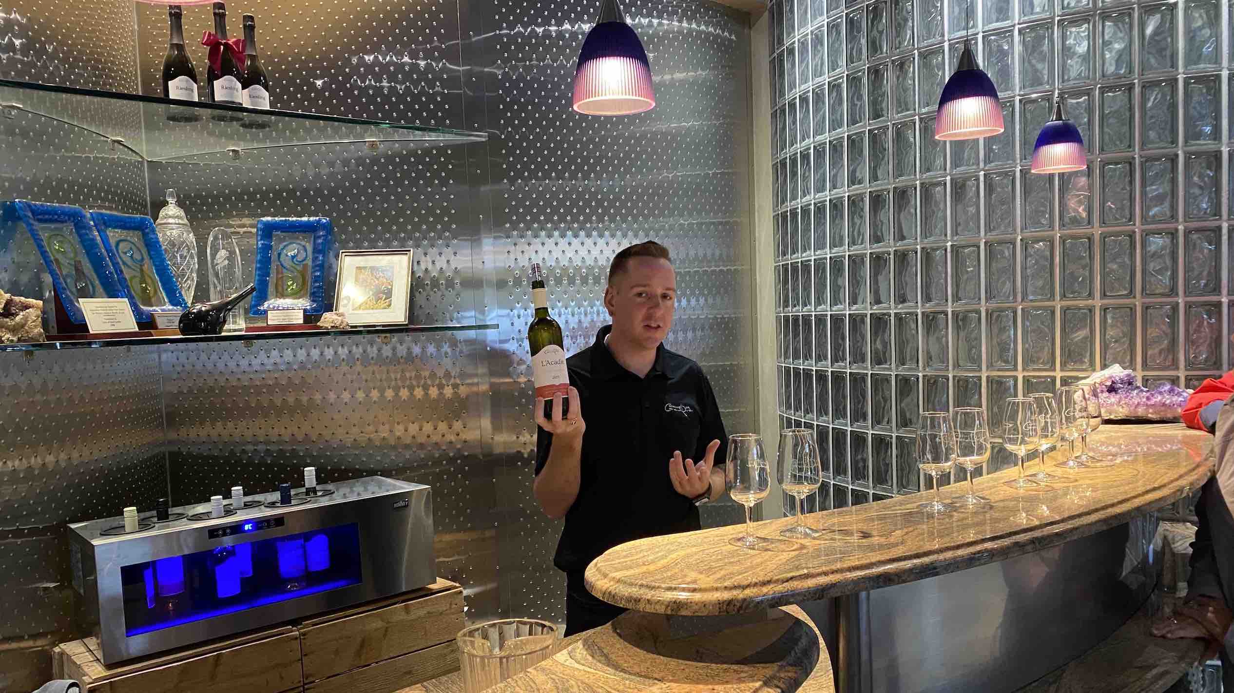 Grand Pré staff serves wine from bottle in bar